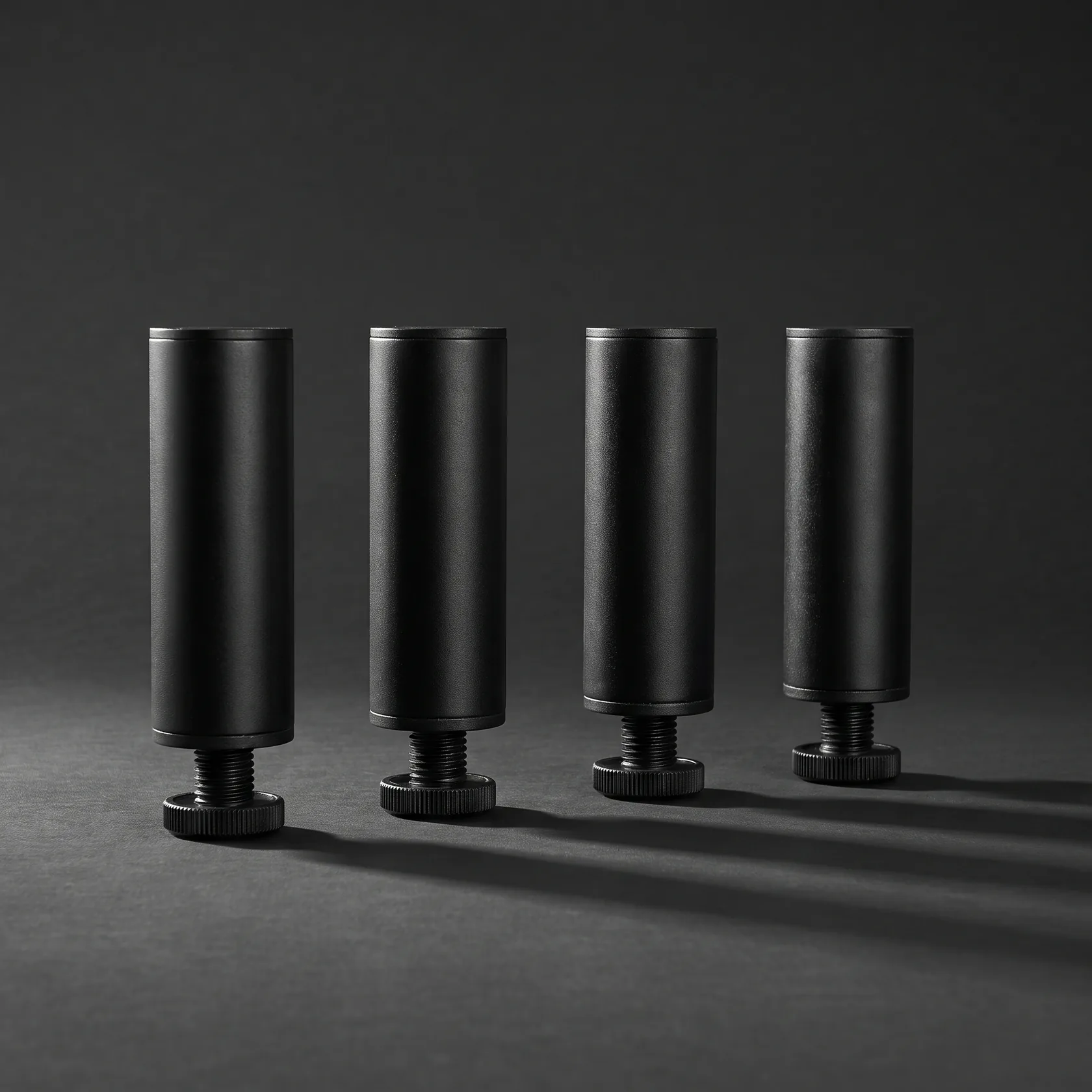 A set of matte black adjustable metal furniture legs